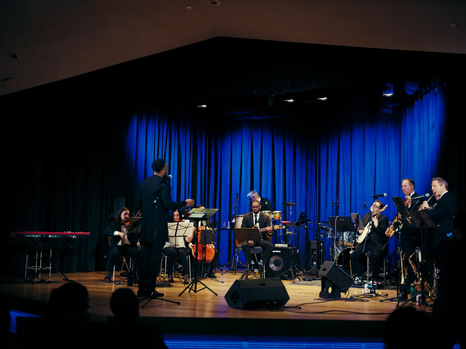 Wide stage shot of King Udofia and the Gbèdu orchestra in performance